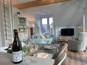 a living room with a bottle of wine on a table at Meerzeit in Eckernförde