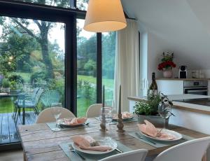 a dining room table with chairs and a large window at Meerzeit in Eckernförde