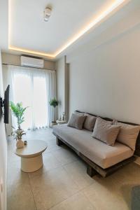 a living room with a couch and a table at Sofia's central suite in Alexandroupoli