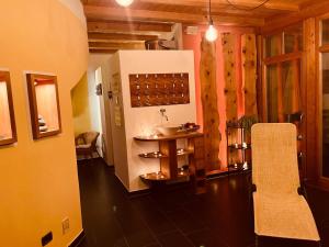 a room with a table and chairs in a building at Residence Zirmer Wohnung Sonne in Castelrotto +26 photos