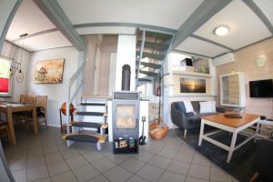 a living room with a fireplace in a house at Ferienhaus 109 - Seepark Kirchheim in Kirchheim