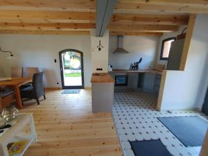 a kitchen and dining room with a table and a counter at Ferienhaus Melkerhaus in Neetzendorf