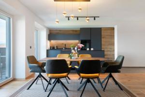 a kitchen and dining room with a table and chairs at Apartment Anna in Soprabolzano