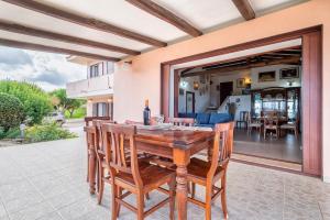 a wooden table and chairs on a patio at Villa Patrizia in Castelsardo