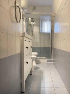a bathroom with a sink and a toilet and a shower at Piave House - Pisa in Pisa +23 photos