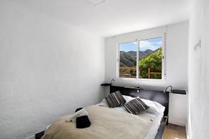 a bedroom with a bed and a window at Casa Cueva in Teror