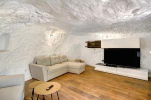 a living room with a couch and a tv at Casa Cueva in Teror