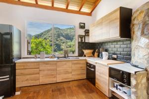 a kitchen with a large window with a mountain view at Casa Cueva in Teror