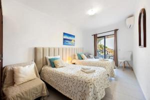 a hotel room with two beds and a couch at Apartamento Mar-colina-sol in Carvoeiro +26 photos