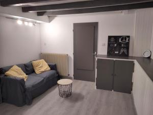 a living room with a couch and a table at Maison au 19 in Bourges
