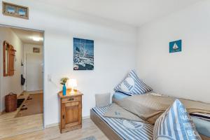 a small bedroom with a bed and a table at Ferienwohnung 'Segelyachten-Perle' in Schilksee