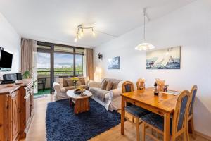 a living room with a table and a couch at Ferienwohnung 'Segelyachten-Perle' in Schilksee