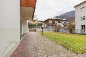 a brick walkway in front of a house at Casa Aliza - Duplex Alpino in Pieve di Bono