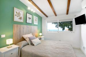 a bedroom with a bed and a window and a television at El chiringuito in Candelaria
