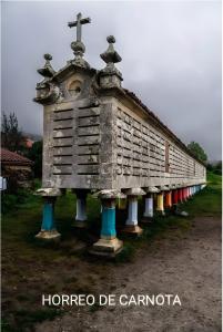 a church with a cross on top of it at O Son in Cee +7 photos