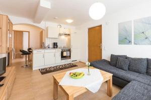 a living room with a couch and a table at Ferienwohnung Lauser Ug in Herdwangen-Schönach