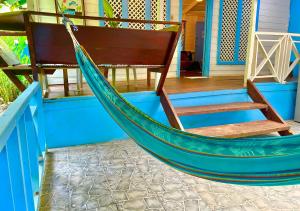 a blue hammock on the porch of a house at Ita Ita Casitas Family Vacation Playa Punta Uva in Punta Uva