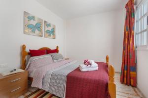 a bedroom with a bed and a dresser and a window at Ático La Estrella in Tejina de Isora