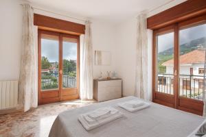 a bedroom with a bed and a large window at Zio Gennaro Residence in Agerola