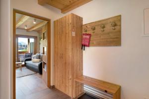 a hallway with a wooden door in a house at Schererhof Morgenrot in Castelrotto