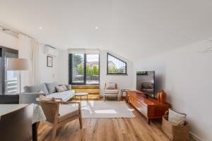 a living room with a couch and a table at Birre House in Cascais