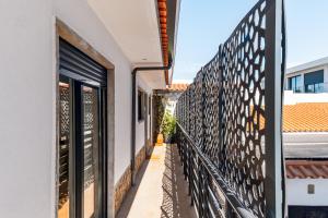 a balcony of a house with a wrought iron fence at Birre House in Cascais