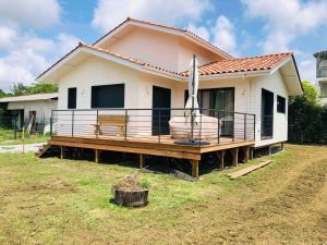 a house with a large deck on top of it at Escapade Tout Confort - Seignosse in Seignosse