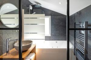 a bathroom with a sink and a mirror at Escapade Tout Confort - Seignosse in Seignosse +22 photos
