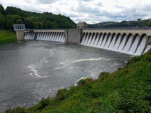 a dam on a river with water flowing through it at Ferienwohnungen Schimsheimer Rhode in Olpe