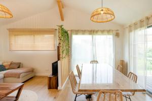a dining room with a table and chairs at Escapade Tout Confort - Seignosse in Seignosse