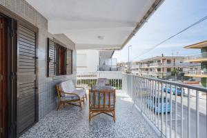 a balcony with two chairs and a table at Llúria 51 in Oliva