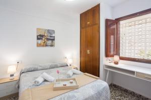 a bedroom with a bed with a tray on it at Llúria 51 in Oliva