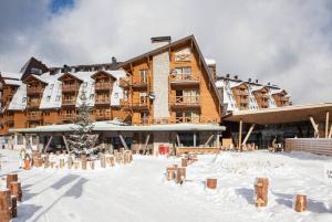 a large building with snow in front of it at Studio Apartment 134B Vucko in Jahorina