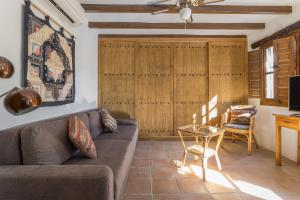 a living room with a couch and a table at Finca el Cerrillo Competa in Cómpeta