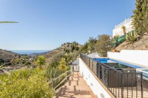a villa with a swimming pool and a hill at Finca el Cerrillo Competa in Cómpeta