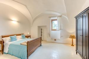a bedroom with a bed and a window at Masseria Scafazzi - Salento in Presicce