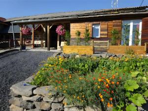 a garden in front of a house with flowers at Le Mont De La Source in Lafarre