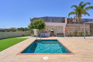 a swimming pool in the backyard of a house at Casa Rural El Granado in Nerja