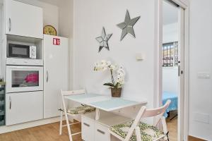 a kitchen with a table and two chairs at Casa Rural El Granado in Nerja
