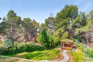 a garden with a gazebo and a path at Bohemia in Jávea
