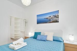 a bedroom with a blue bed with a view of the ocean at Casa Rural El Granado in Nerja +22 photos