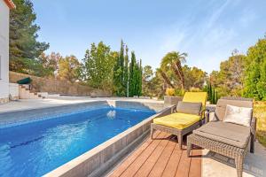 a patio with two chairs and a swimming pool at Bohemia in Jávea