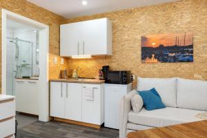 a living room with a couch and a kitchen at Apartment am Seefischmarkt in Kiel +16 photos