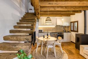 a kitchen and dining room with a table and chairs at El Niu in Montagut