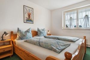 a bedroom with two beds and a window at Haus Hilebrand in Kressbronn am Bodensee