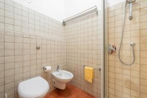 a bathroom with a toilet and a sink and a shower at Agata House in Muravera +14 photos