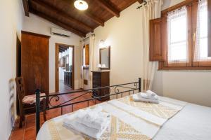 a bedroom with a bed with towels on it at Agata House in Muravera