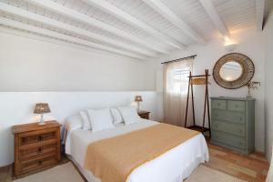 a white bedroom with a bed and a mirror at Casa de Benafim 51 in Benafim +14 photos
