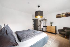 a bedroom with a large bed and a chair at Eifel-resort in Waxweiler