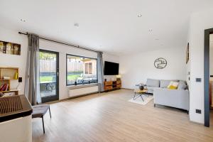 a living room with a couch and a tv at Eifel-resort in Waxweiler